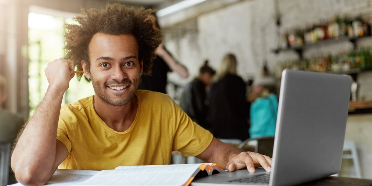 A UI designer sitting at a computer, smiling