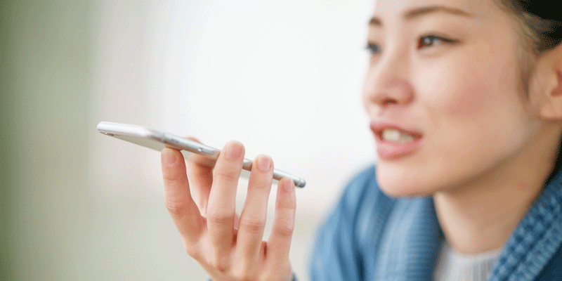 A person speaking into their mobile phone