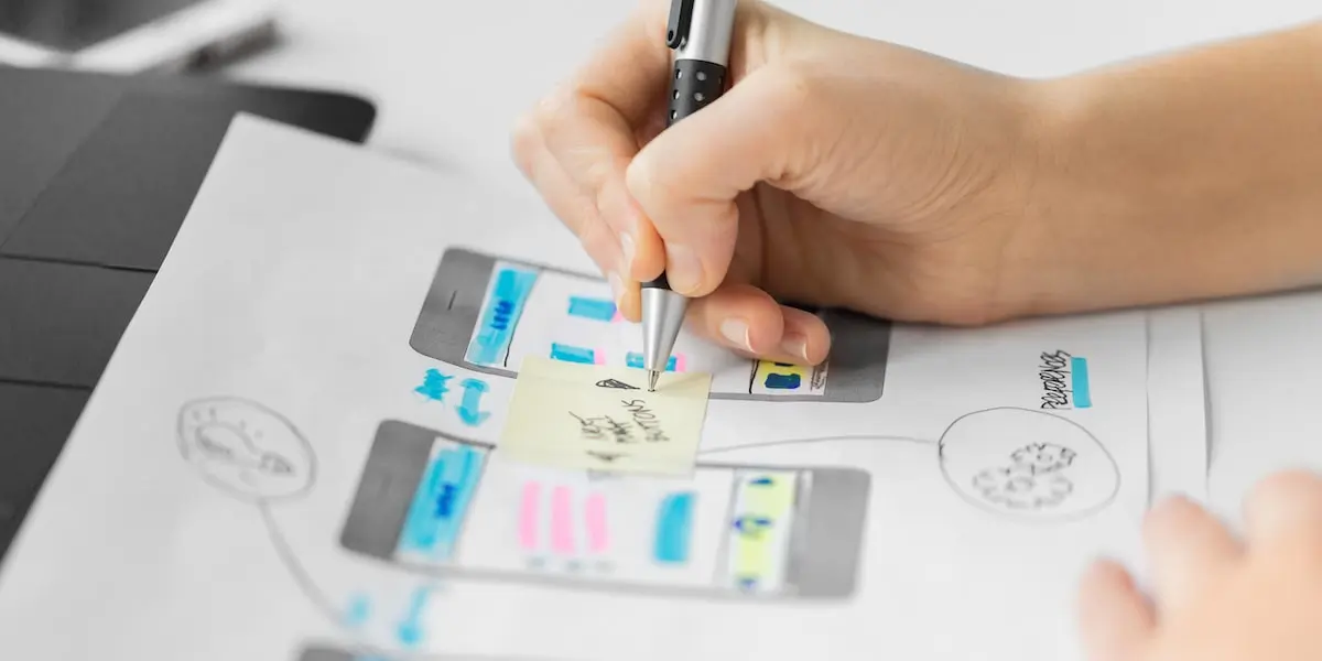 A UI designer sketching out wireframes for a website