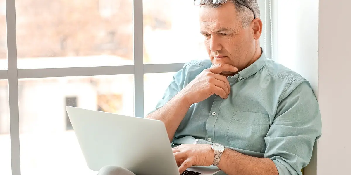 A data analytics bootcamp student working on a laptop