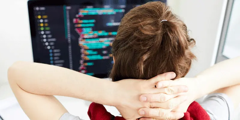A JavaScript developer looking at code on his screen