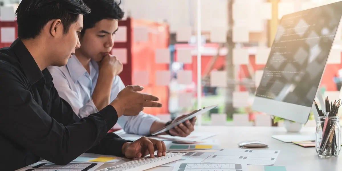 Two UI designers sitting at a desk