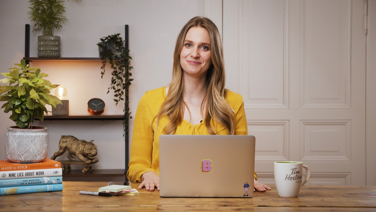 Brittni Bowering, content strategist and branding expert, sitting at a desk, smiling