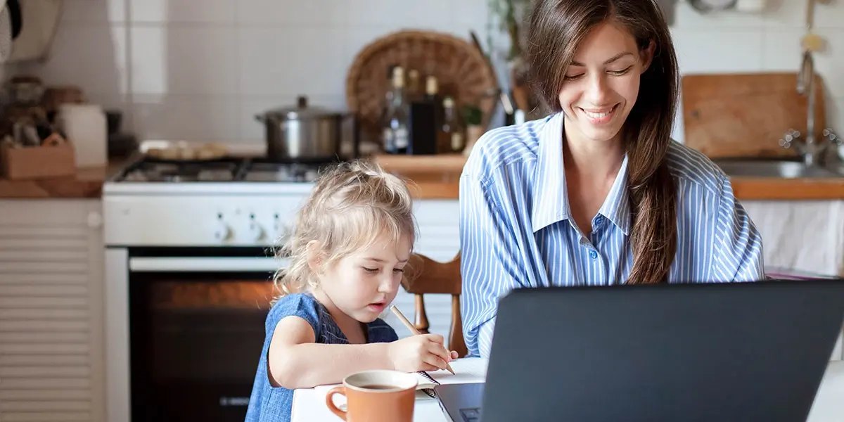 A data analyst working from home with a child next to them
