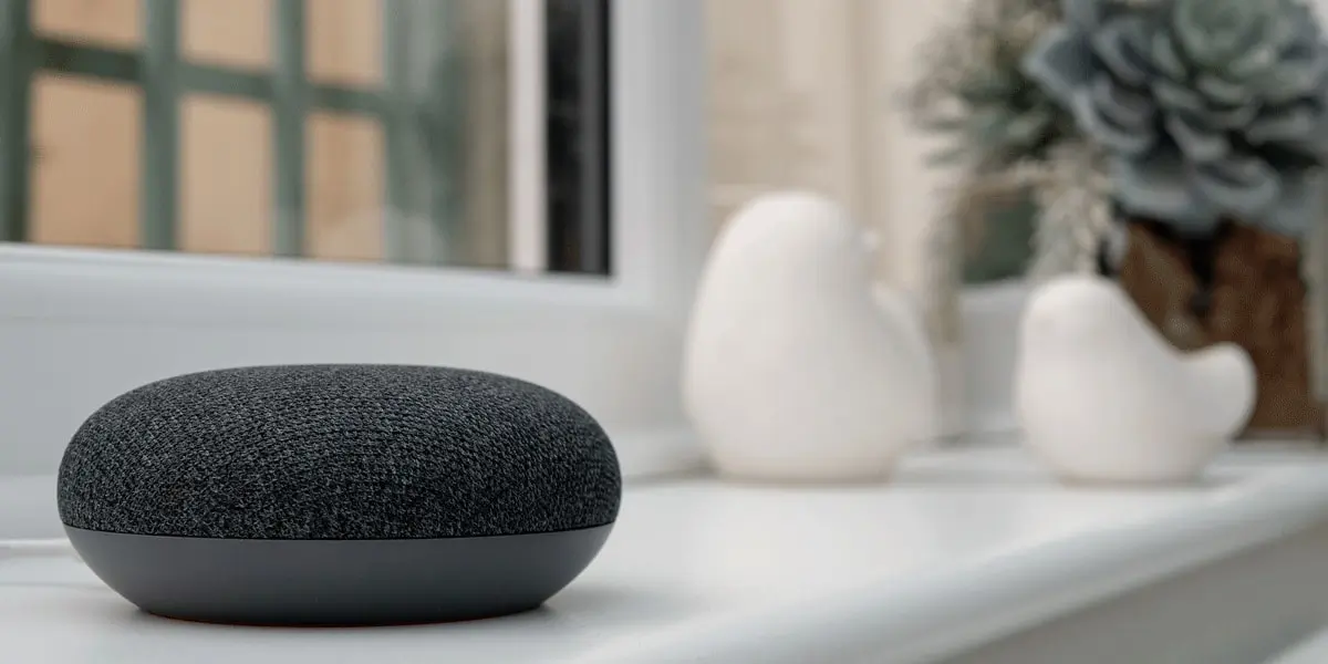 A google VUI device sitting on a tabletop in someone's home