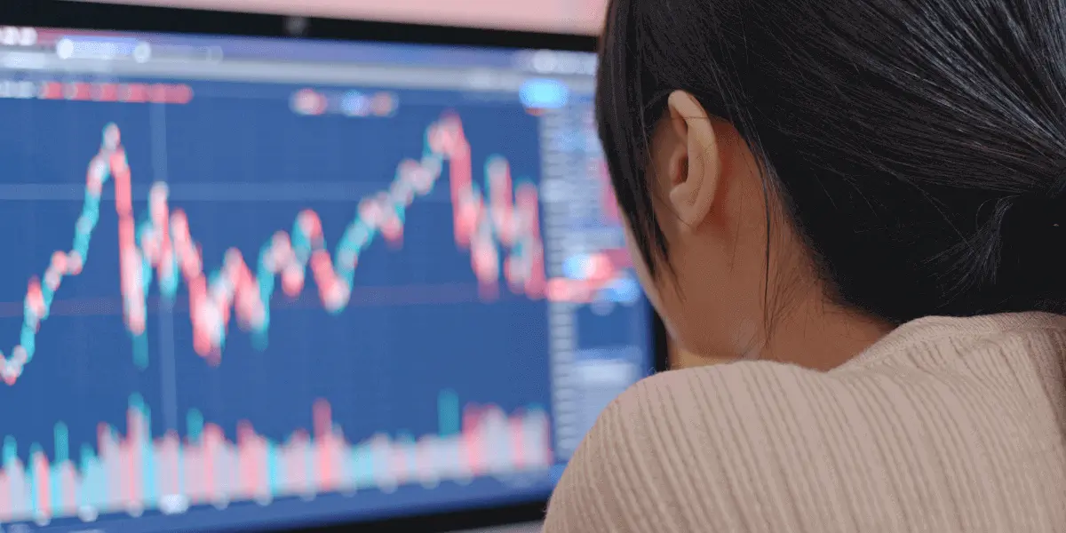 A data analyst looking at graphs on a computer