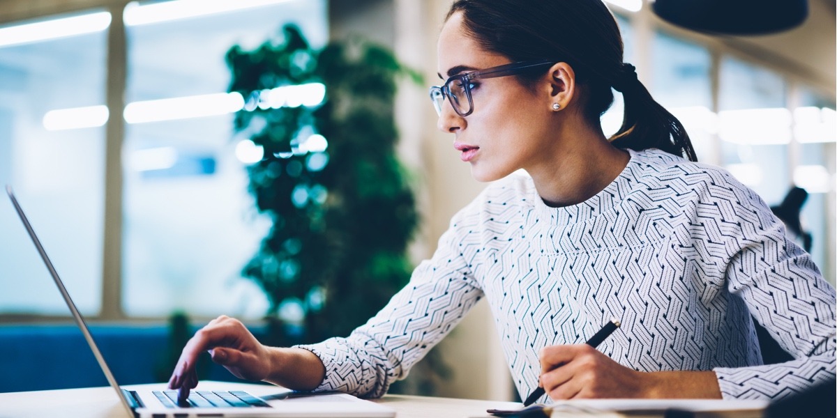 A UX designer working at a computer, examining the information architecture of a product