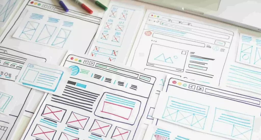 UI design wireframe paper sketches lying on a table
