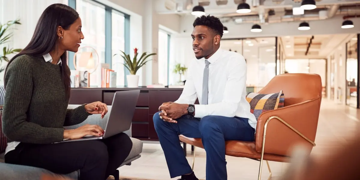 A tech professional sitting on a couch, having a job interview