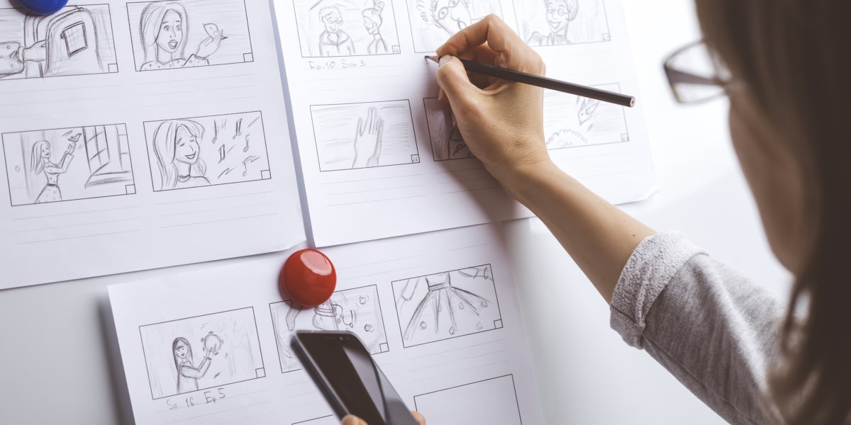 A designer sketching a storyboard
