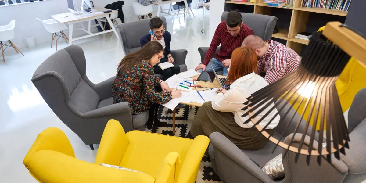 A group of aspiring social media specialists sitting in a co-working space on comfortable chairs