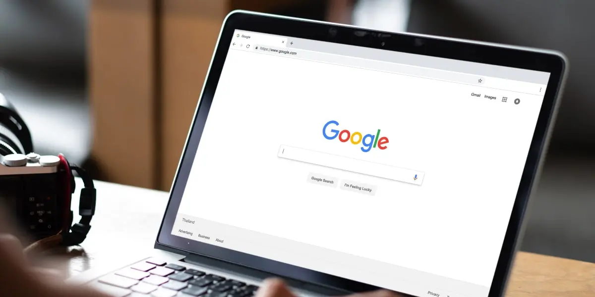 A laptop with the Google search bar visible on the screen