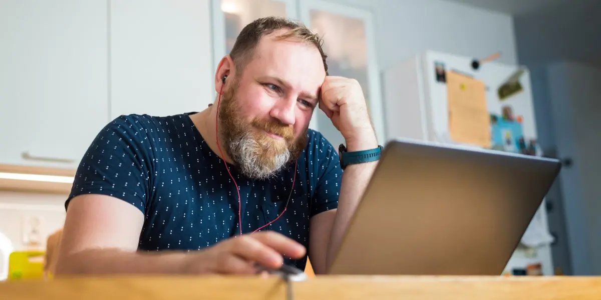 An aspiring digital marketing specialist sitting at a desk, working on a laptop