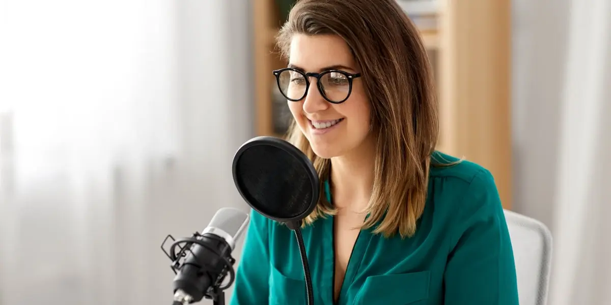 A social media manager sitting at a desk, speaking into a microphone