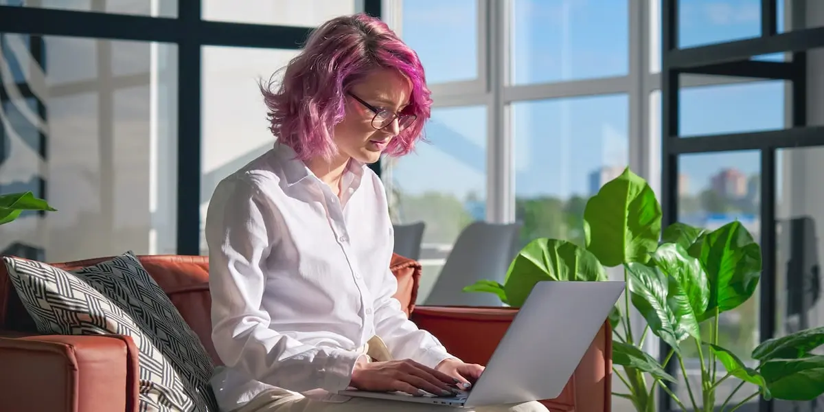 A UX designer working remotely applying Miller's Law to a project on her laptop.