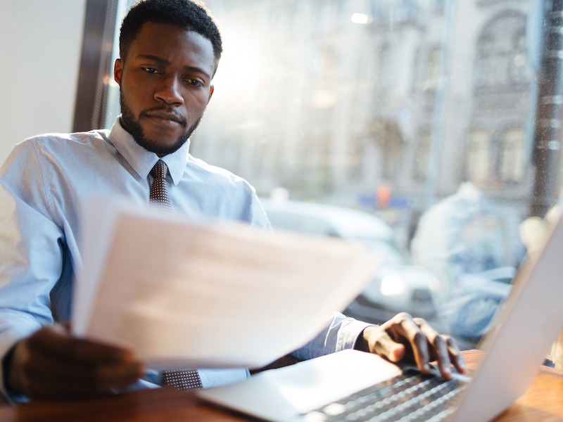 Business systems analyst reading a work document