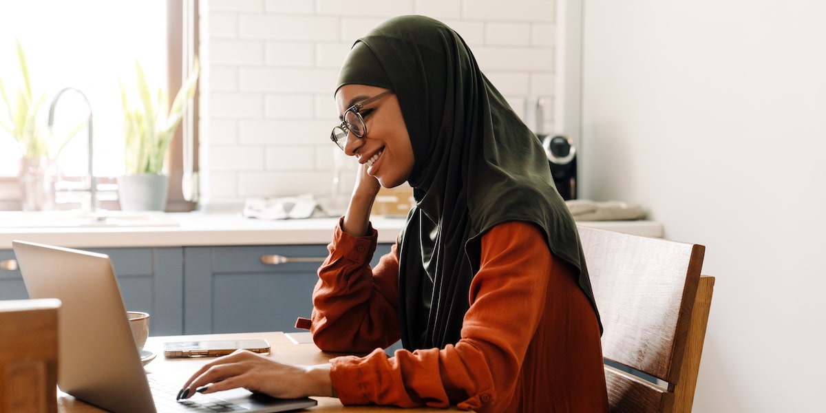 Woman working on her digital marketing skills from her home office.