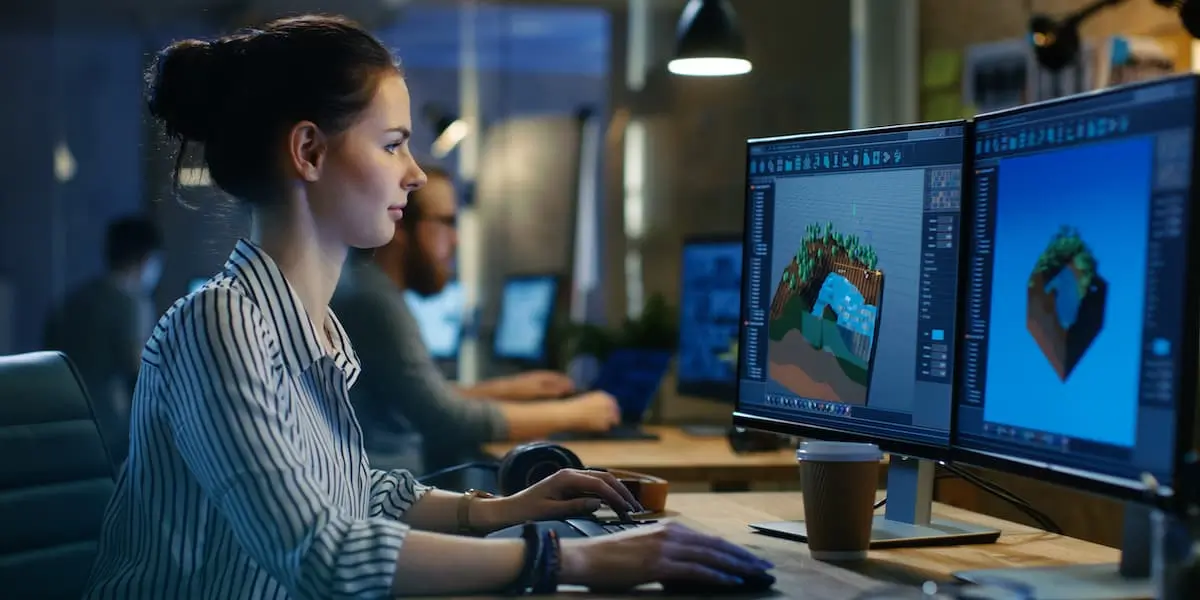 A game ui designer works on a game at her computer