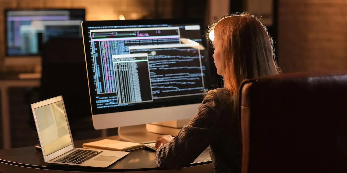 Woman working one of the highest paying software engineering jobs sits at her computer screen.