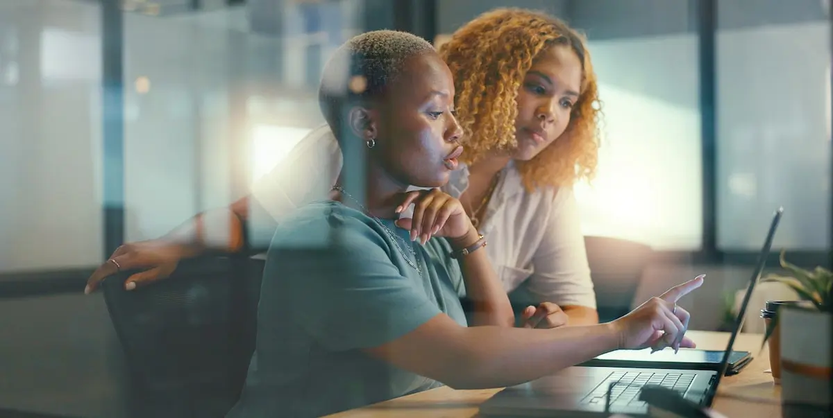 data scientists are a key part of germanys technology future Two data scientists examining something on a laptop screen.