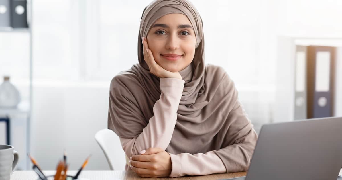 A developer in a headscarf picking up coding tips from reddit.