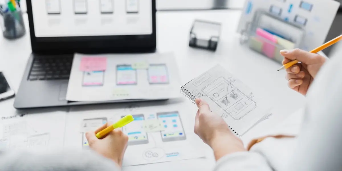 Two designers review the data they've collected while creating mobile app wireframes.