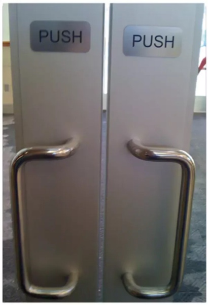 Metal doors with handles and signs that say, "Pull"