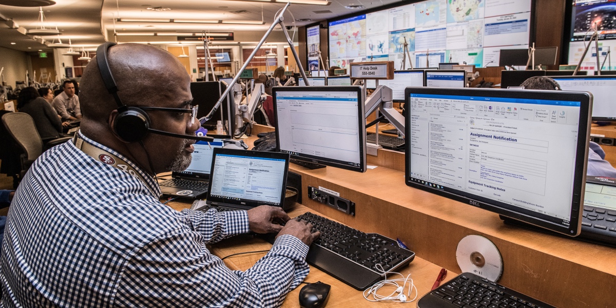 A man working at multiple computer screens at the CDC Emergency Operations Center