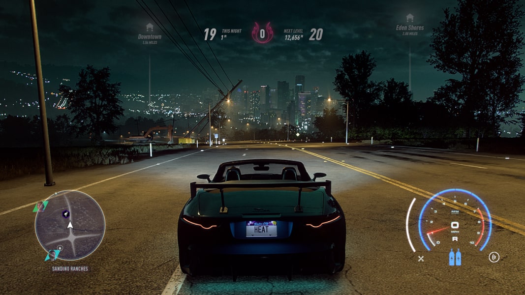Need for Speed Heat Screenshot shows a sports car driving through a city at night