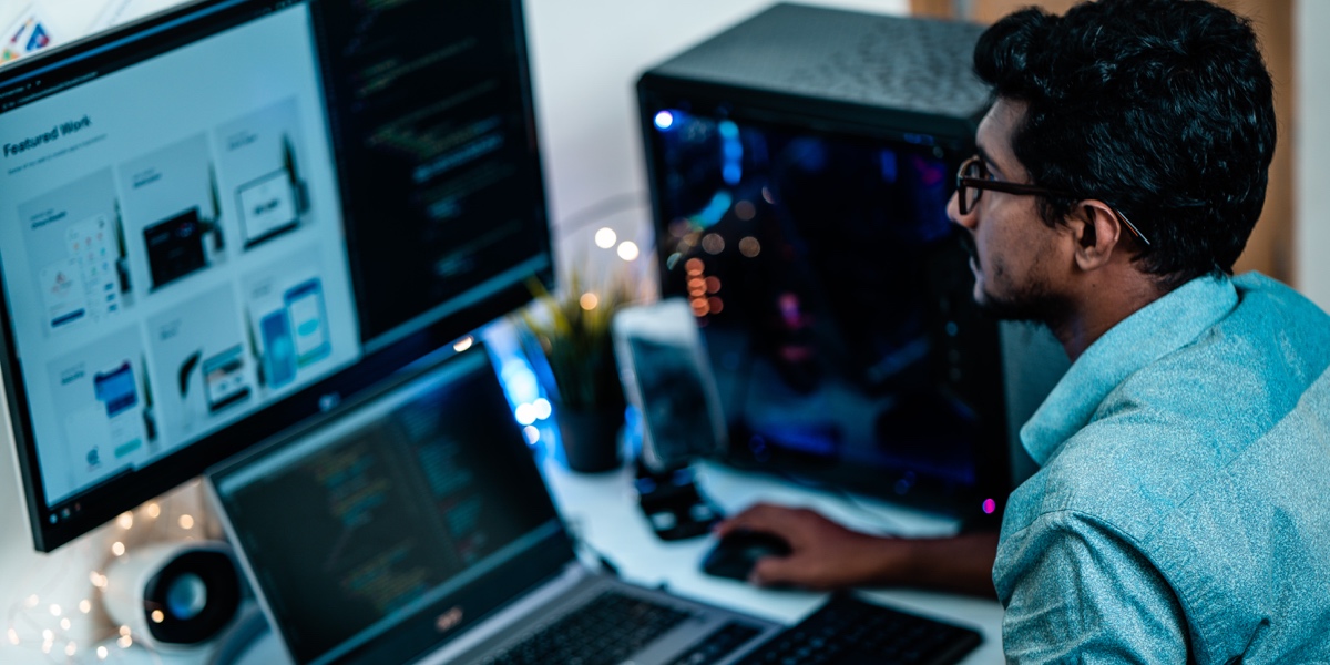 A UX designer sitting at a desktop computer, working on their UX portfolio