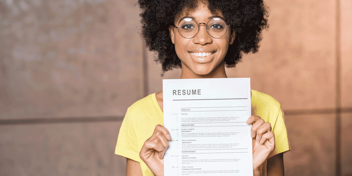 A UX designer holding up her resume