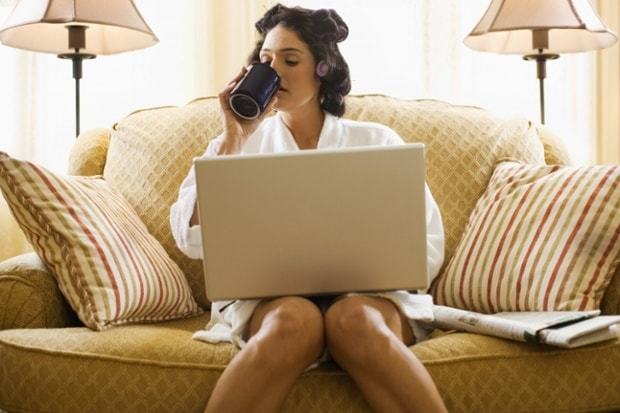 Woman working from home, sipping a coffee